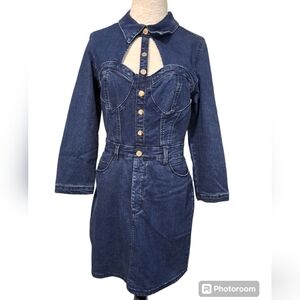 Bebe denim mini dress featuring a front cutout and button accents. Size 10